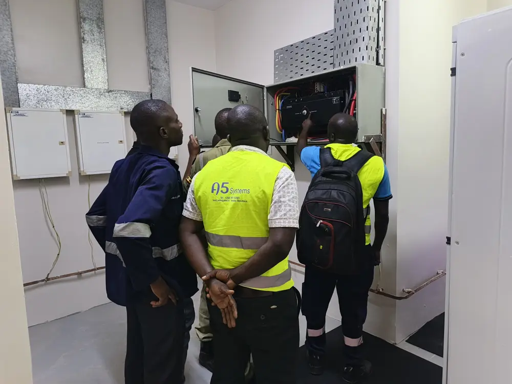 A5 Systems engineers inspecting an electrical cabinet during a site visit